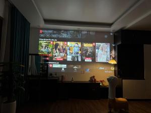 a large screen in a living room with a tv at 05 Homestay Cinema in An Khê