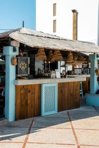a building with a bar with at Hotel Pinos Playa in Cala Santanyi