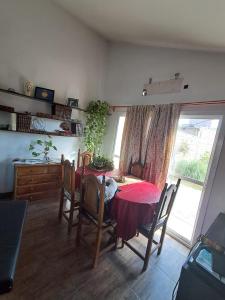 a dining room with a table and chairs and a window at Habitación Privada en La Casa de Thor in Trelew +50 photos
