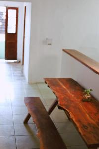 a wooden bench sitting next to a wall at LahSelva Pousada e Hostel in Itacaré +42 photos
