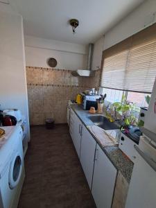 a kitchen with a sink and a counter top at Habitación Privada en La Casa de Thor in Trelew