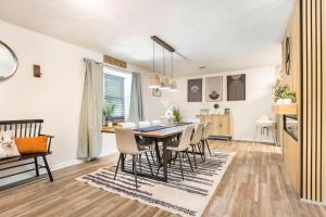 a dining room and living room with a table and chairs at Charming Farmhouse Getaway 7 Beds in Centerville +76 photos
