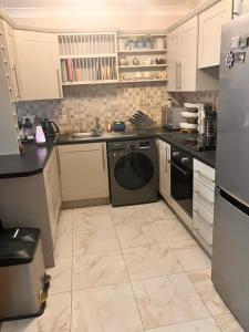 a kitchen with a washer and a sink and a dishwasher at ChezVous in Swords