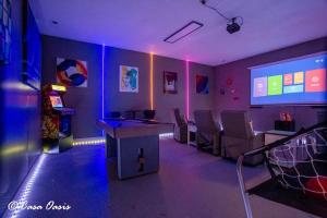 a room with a gaming room with chairs and a screen at Madison Luxury 4BR Theater Arcade Firepit in Madison