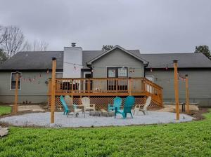 a deck with chairs and a playground in front of a house at Madison Luxury 4BR Theater Arcade Firepit in Madison +91 photos