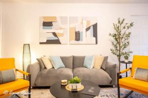 a living room with a couch and two chairs at Madison Luxury 4BR Theater Arcade Firepit in Madison