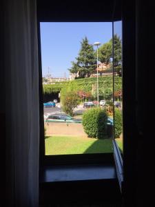 a window in a room with a view of a park at Diana Apartment Savona in Savona