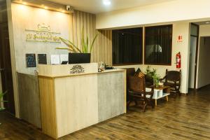 an office lobby with a reception desk and chairs at El Sueño Del Rey in Majes