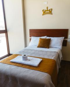 a bed with a tray with a napkin and a cup on it at El Sueño Del Rey in Majes +5 photos