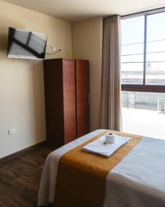 a hotel room with a bed with a towel on it at El Sueño Del Rey in Majes
