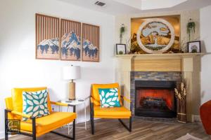 a living room with two chairs and a fireplace at Sunrise Tranquil Cottage 3BR RAFB Pet Friendly in Warner Robins