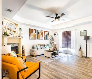 a living room with a yellow couch and a fireplace at Sunrise Tranquil Cottage 3BR RAFB Pet Friendly in Warner Robins +47 photos