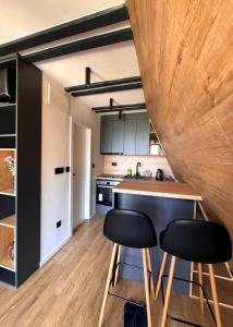 a kitchen with a counter and two stools at a table at View Retreat in Visoko