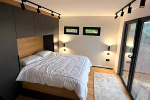 a bedroom with a bed and a large window at View Retreat in Visoko