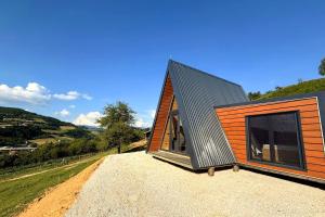 a small house with a black roof on a hill at View Retreat in Visoko