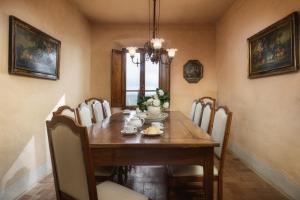 a dining room with a wooden table and chairs at Castello di Albola in Radda in Chianti