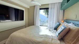 a bedroom with a bed and a large window at BELA VISTA RESERVAs in Petrópolis +68 photos