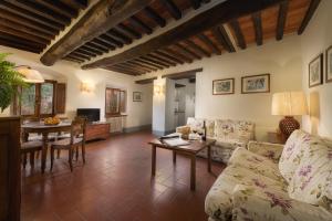 a living room with a couch and a table at Castello di Albola in Radda in Chianti