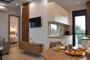 a kitchen and living room with a table with a bowl of food at Saonia Apartment in Samothraki