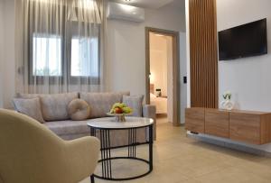a living room with a couch and a table at Saonia Apartment in Samothraki
