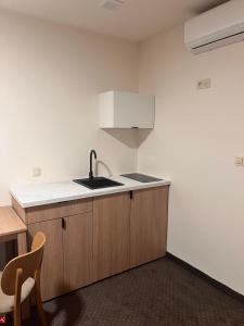 a kitchen with a sink and a counter top at Aura Pokoje na Wynajem in Wojnicz