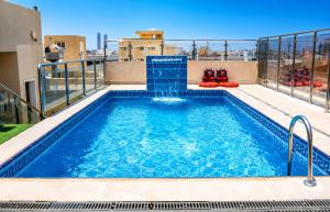 a swimming pool on the roof of a building at Areen Al Naeem Served Apartments in Jeddah