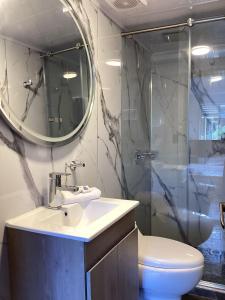 a bathroom with a sink and a shower with a mirror at Paramount Hotel in Bogotá