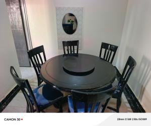 a black table and chairs in a room at JA Haven Suite in Lira