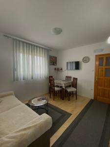 a living room with a couch and a table at Apartment VUK in Žabljak