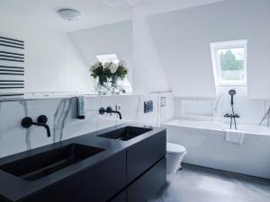 a white bathroom with a sink and a tub at Blissberg Winterberg in Winterberg +59 photos