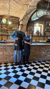a man and a boy standing in front of a bar at Hotel Stork in Lednice