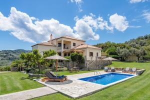 a villa with a swimming pool and a house at Villa Anatoli in Skopelos Town