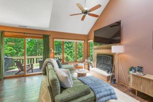 a living room with a couch and a flat screen tv at King Bed Fire Pit Pool & Walk to North Course in Galena