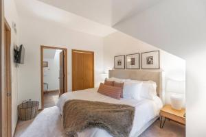 a white bedroom with a large bed with a blanket at King Bed Fire Pit Pool & Walk to North Course in Galena +71 photos