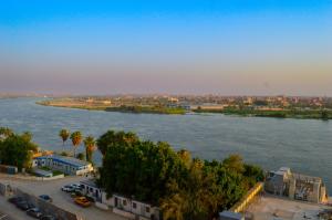 an aerial view of a river with a city at Nile Pyramidal view place in Cairo