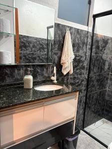 a bathroom with a sink and a shower at Aconchego Central in Tiradentes +9 photos