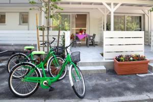 two bikes parked next to each other in front of a house at Residence La Pigna in Rosolina Mare