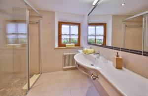 a bathroom with a sink and a shower at Hotel Pension Geiger in Serfaus +78 photos