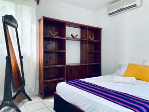 a bedroom with a bed and a wooden book shelf at Economic Apartments & Rooms next to the beach in Cancún