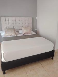 two beds sitting next to each other in a room at Hotel Santander Plaza in Neiva