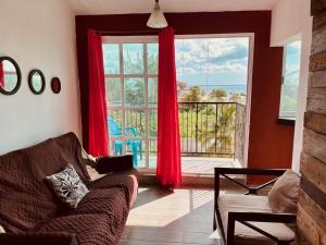 a living room with a couch and a large window at Economic Apartments & Rooms next to the beach in Cancún