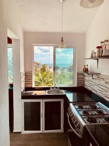 a kitchen with a sink and a window in it at Economic Apartments & Rooms next to the beach in Cancún