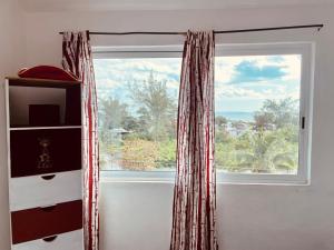a window in a room with a large window at Economic Apartments & Rooms next to the beach in Cancún