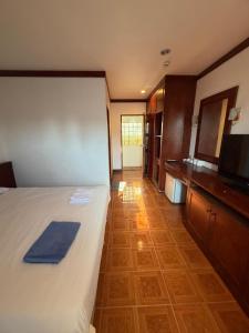 a room with a bed and a television and a kitchen at Vibes Solution in Patong Beach