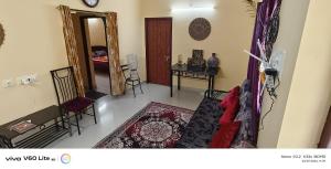 a living room with a couch and a mirror at Sky park homestay in Yercaud
