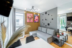 a living room with a couch and a table at Baltic Apartments in Pobierowo
