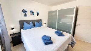 a bedroom with a bed with blue towels on it at K&D in Rijeka