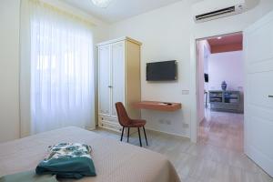a bedroom with a bed and a chair and a desk at Donna Maria Apartments - Amami Collection in Amalfi