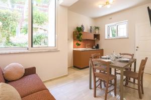 a kitchen and dining room with a table and chairs at Donna Maria Apartments - Amami Collection in Amalfi +16 photos