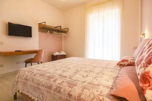 a bedroom with a bed and a desk and a television at Donna Maria Apartments - Amami Collection in Amalfi